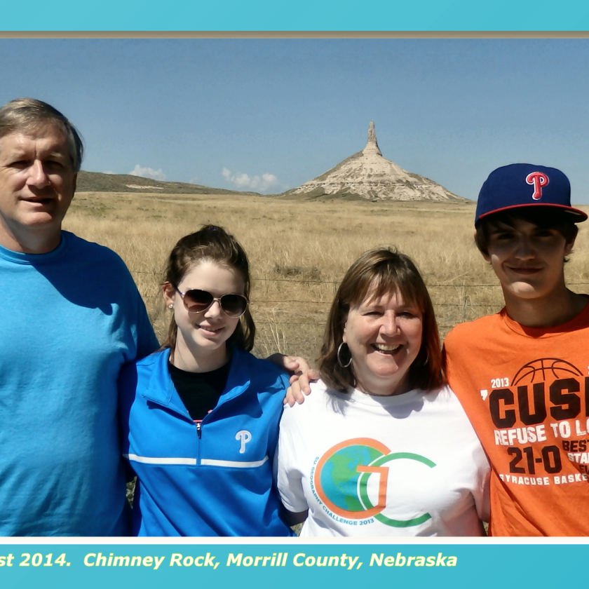 Anne and her family standing in front of Chimney Rock, a significant natural and historical feature in Nebraska.